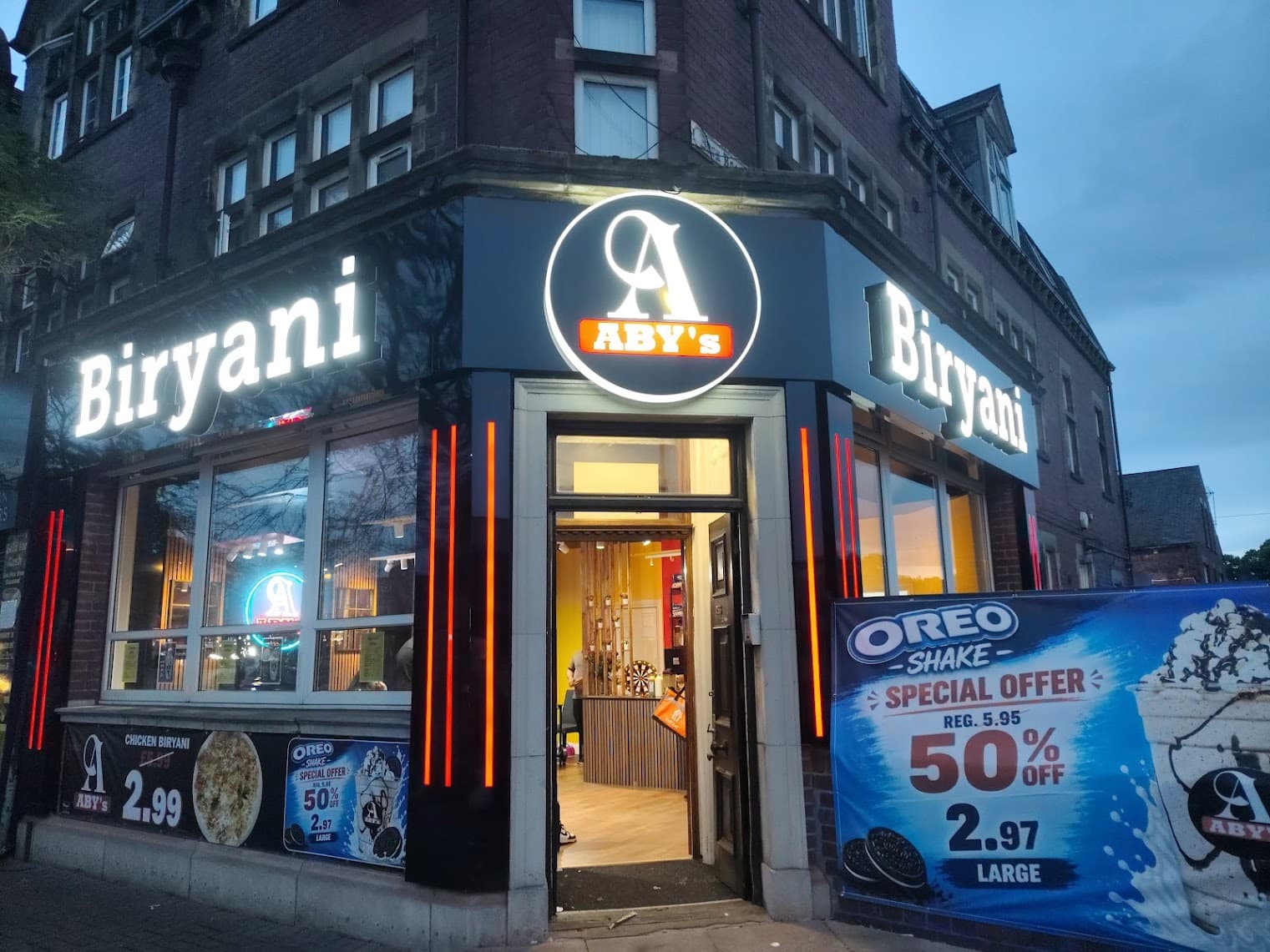 ABY's Biryani Leeds storefront glowing at night on Roundhay Road